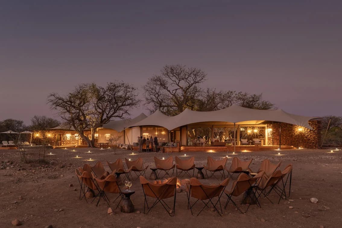 Desert Rhino Camp with tables laid at dusk