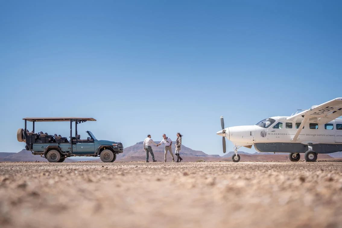 Desert Rhino Camp – safari vehicle and Cessna 208 at the airstrip