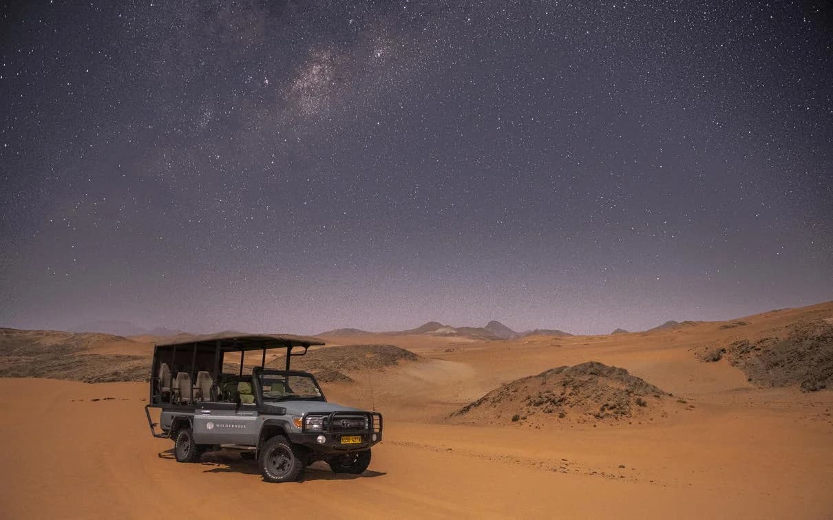 Safari vehicle under the Milky Way at Serra Cafema
