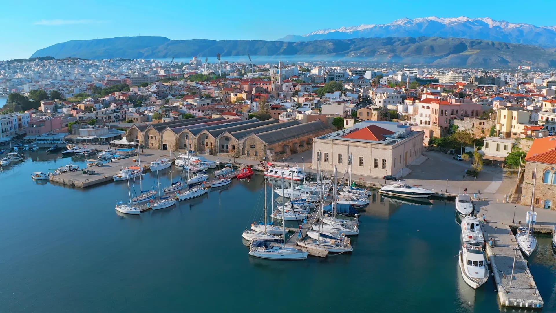 The old harbour of Chania from the air, with Crete's White Mountains behind